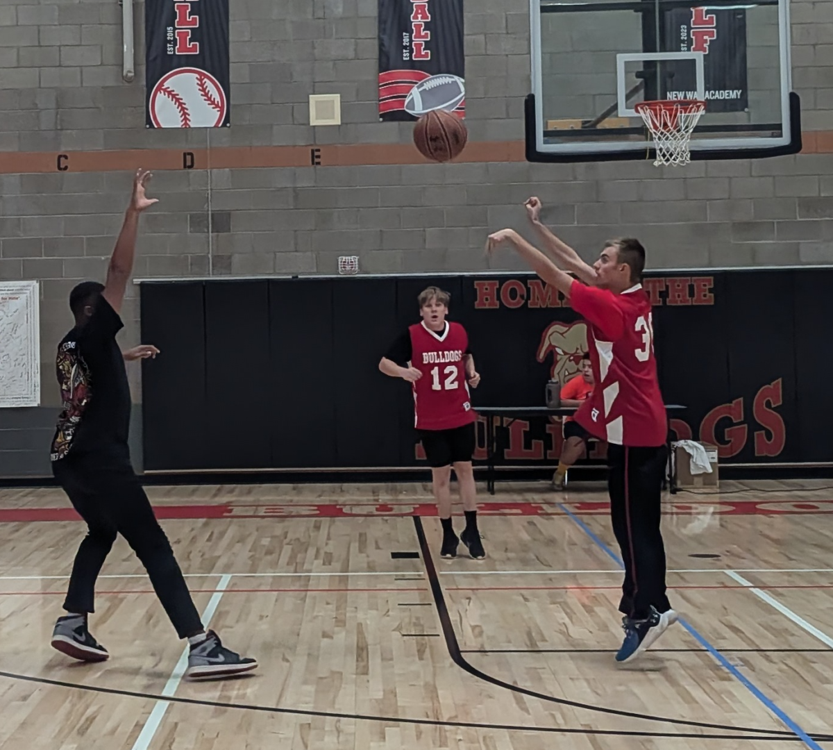 Blake shoots a 3-pointer over Kai during the Championship.