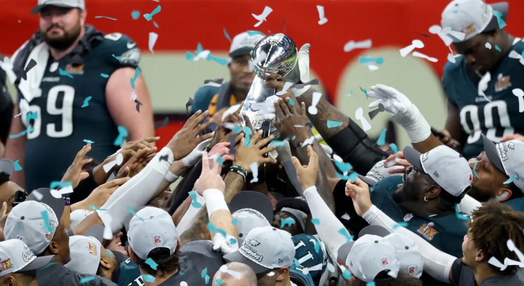 The Eagle celebrate their victory by hoisting The Lombardi Trophy.