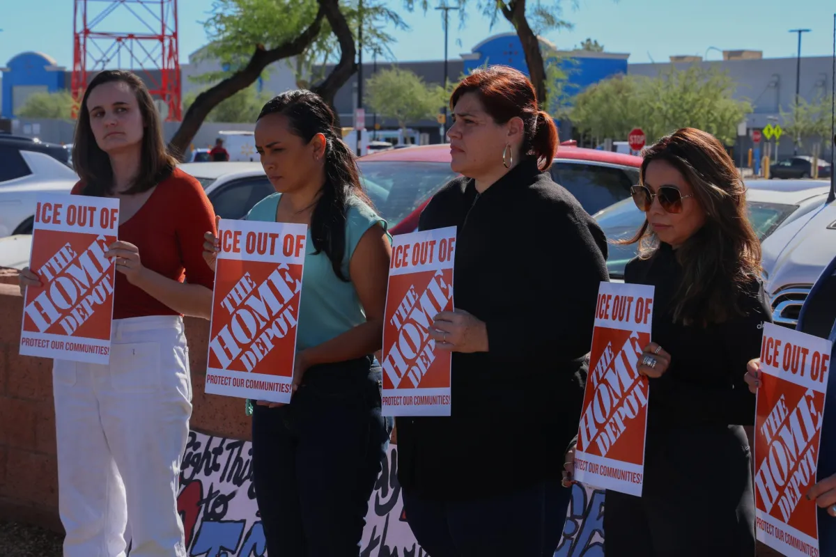 Home Depot prostesters stand in  unison against ICE.

