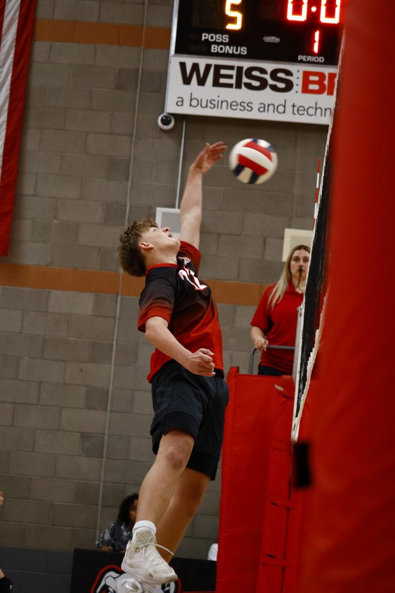 Ryan Spiking a ball to the back of the court 